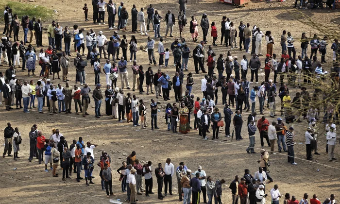 kenyans queueing outside a polling station as they wait to cast their ballot votes in the general elections