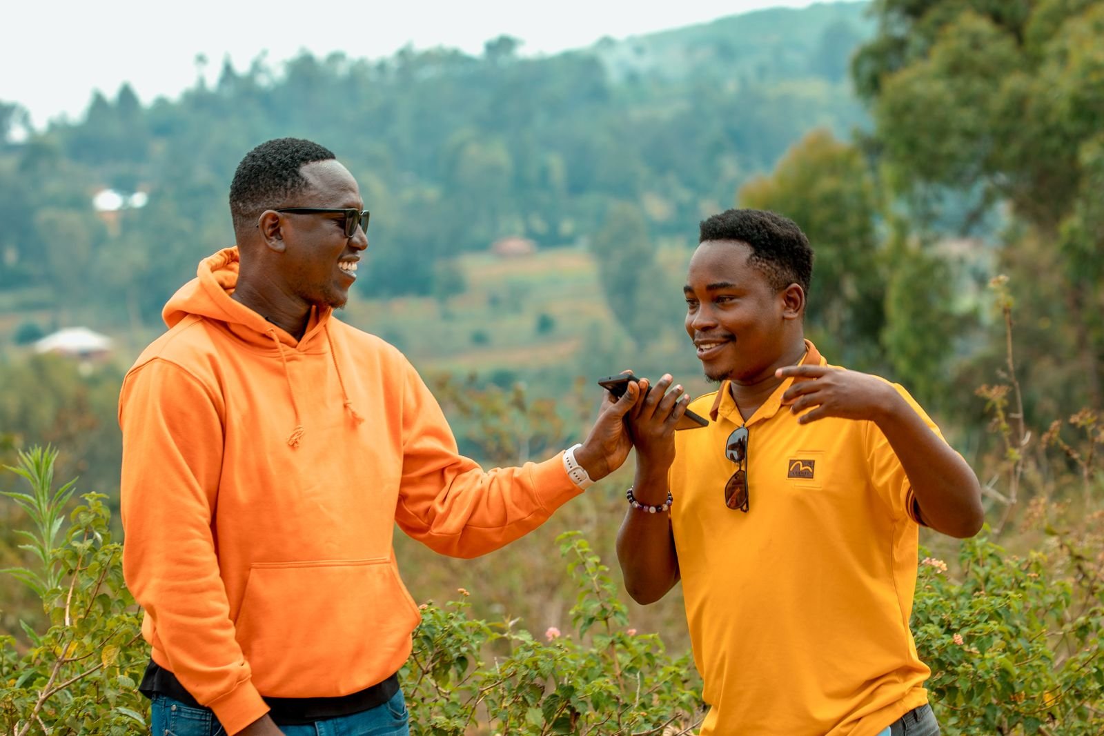 Two young Kenyan men in an animated conversation outdoors in Homa Bay